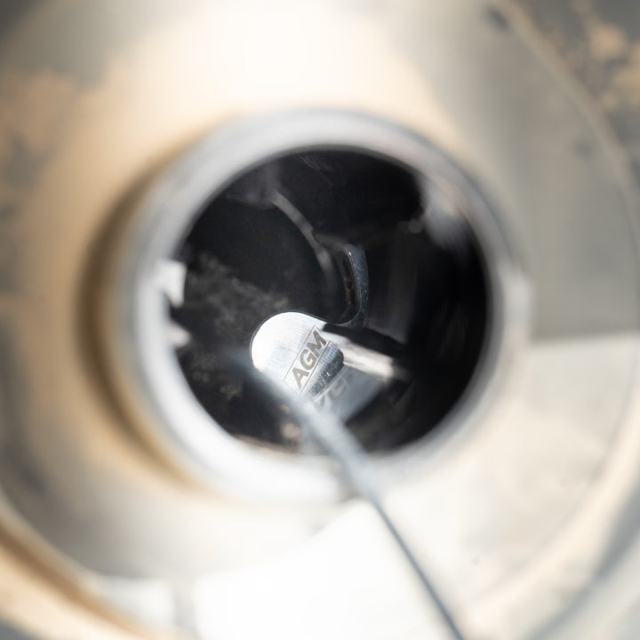 AGM EXR Tank_fuel nozzle spraying into stock tank