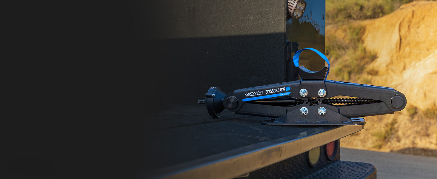 AGM Scissor Jack HD on the tailgate a vehicle with a blurred natural background