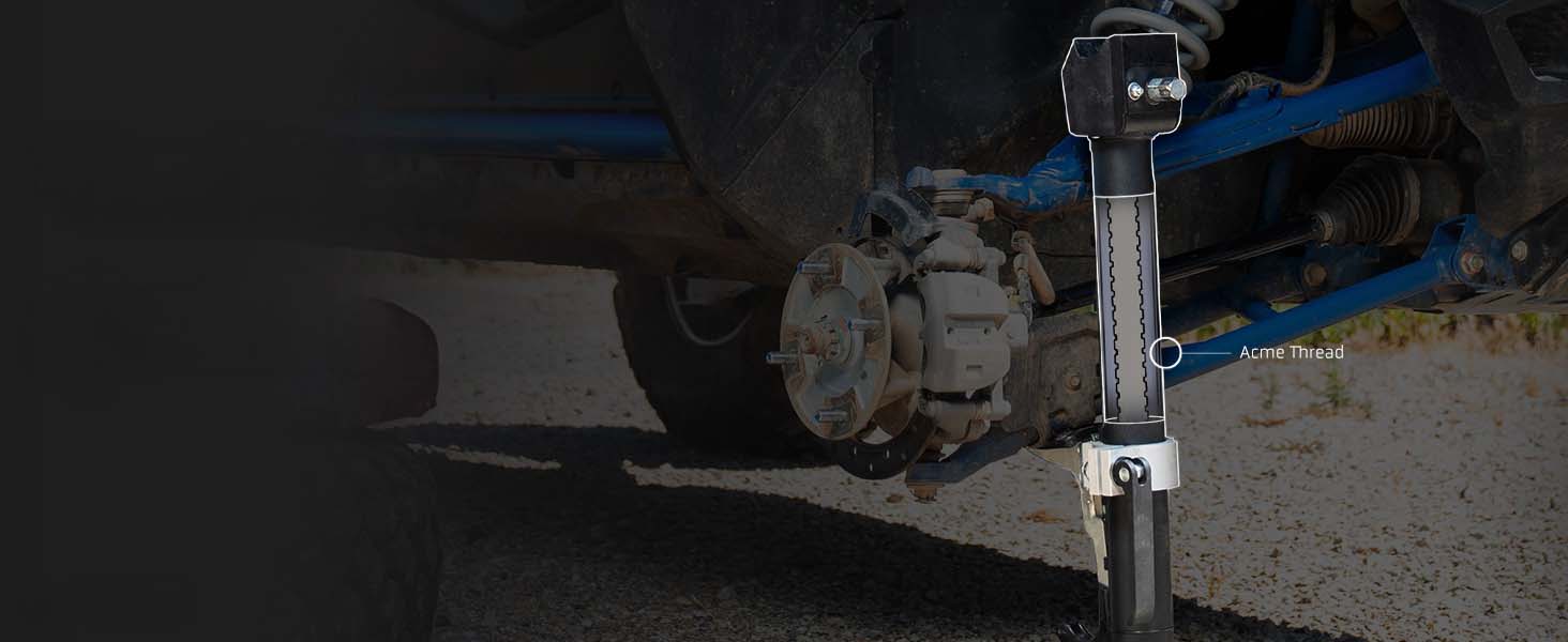 A exploded view of an AGM Manual Jack sport positioned against blue suspension components on an outdoor paved surface.
