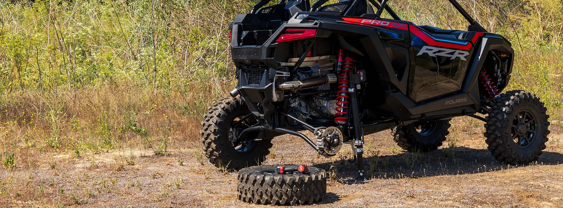 polaris pro xp lifted with AGM Electric Jack PRO_rear tire removed_vehicle outdoors
